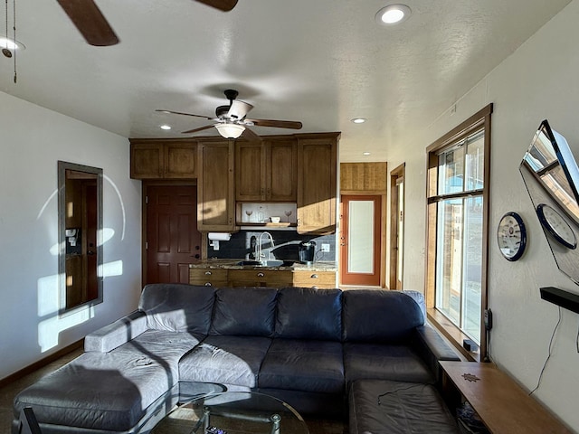 living room featuring sink and ceiling fan