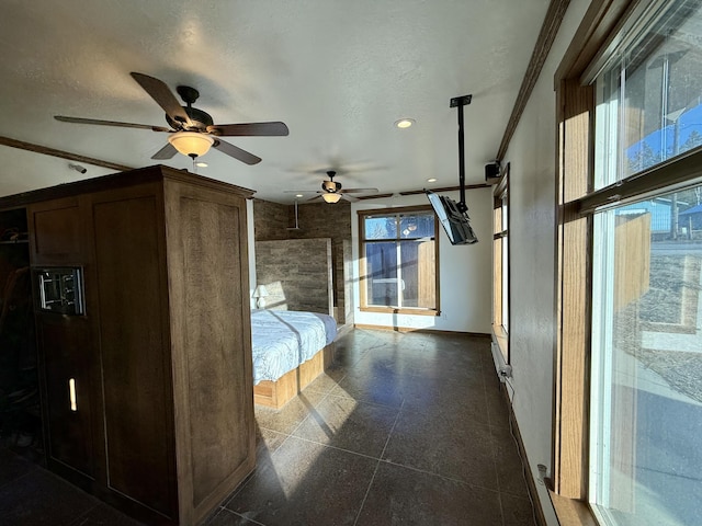 unfurnished bedroom featuring crown molding, a textured ceiling, and ceiling fan