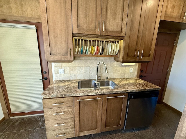 kitchen featuring tasteful backsplash, sink, dark stone counters, and dishwasher