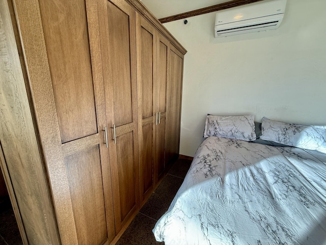 tiled bedroom featuring a wall mounted air conditioner and a closet