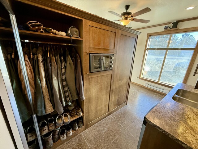 closet with a baseboard radiator and sink