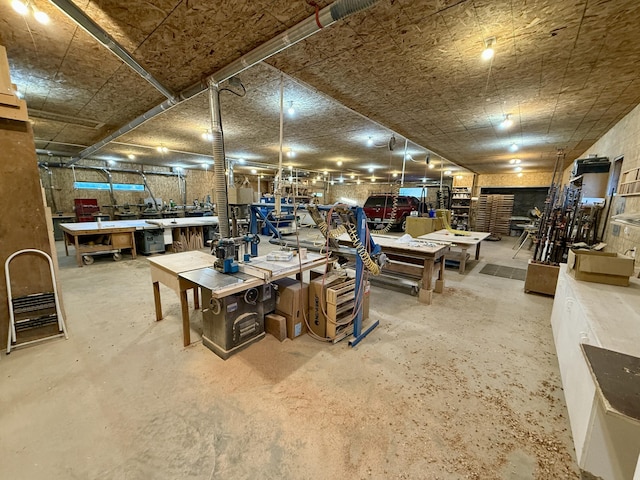 miscellaneous room featuring concrete flooring and a workshop area