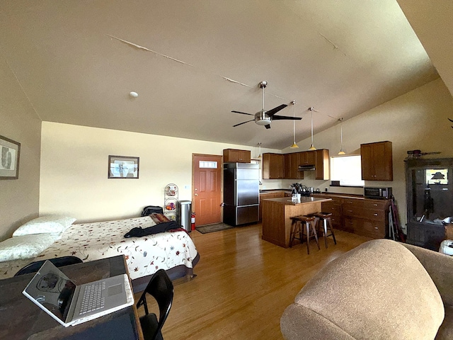 108 Grizzly Loop, Republic, WA 99166 - bedroom featuring built in refrigerator, dark wood-style flooring, and vaulted ceiling
