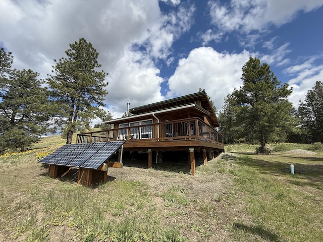 108 Grizzly Loop, Republic, WA 99166 - rear view of house featuring solar panels and a deck