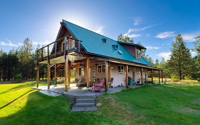 20 River Ranch Rd, Kettle Falls, WA 99141 - rear view of property with a yard, a patio, and metal roof