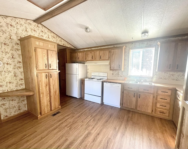 kitchen featuring sink, white appliances, light hardwood / wood-style flooring, and lofted ceiling with beams