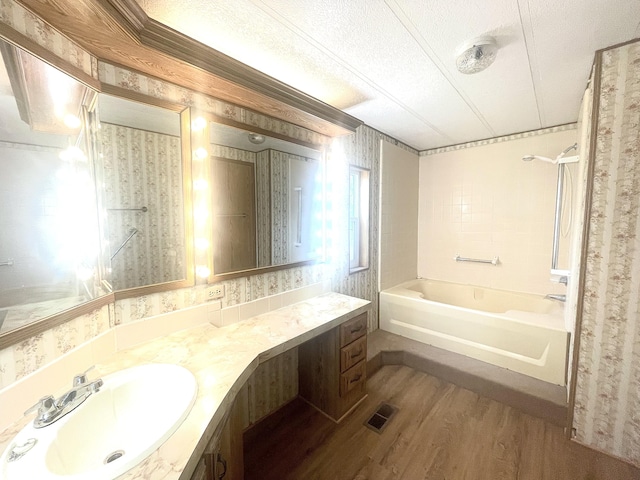 bathroom featuring wood-type flooring, shower / bath combination, a textured ceiling, and vanity