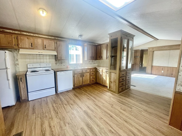 kitchen with sink, white appliances, lofted ceiling with beams, and light hardwood / wood-style flooring