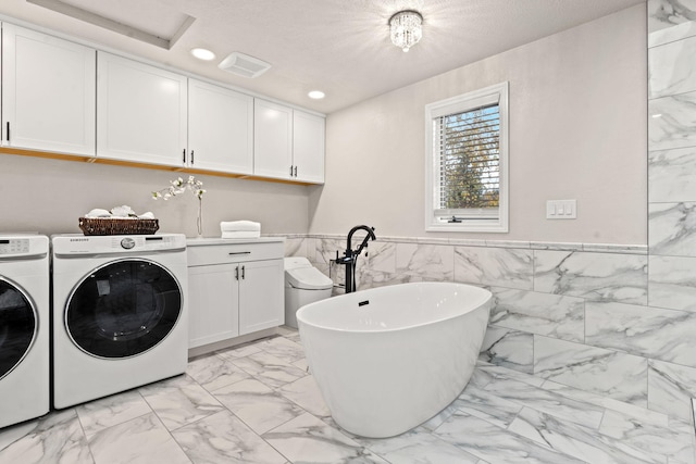 4203 S Suncrest Ln, Spokane Valley, WA 99037 - laundry room featuring light marble finish flooring, washing machine and clothes dryer, cabinet space, recessed lighting, and tile walls
