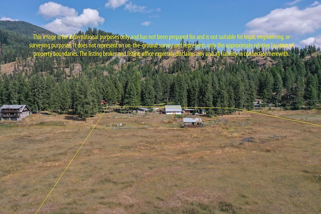 birds eye view of property with a mountain view and a rural view