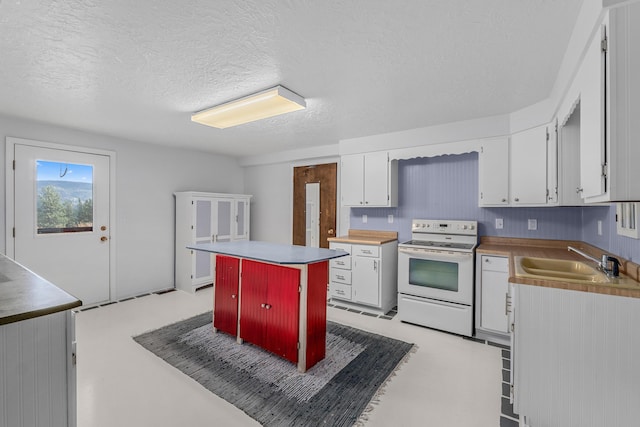 kitchen with a center island, electric range, white cabinetry, and sink