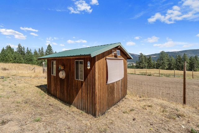 view of outbuilding featuring a mountain view and a rural view