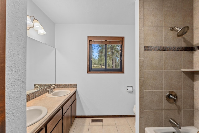 bathroom with vanity, toilet, and tile patterned flooring