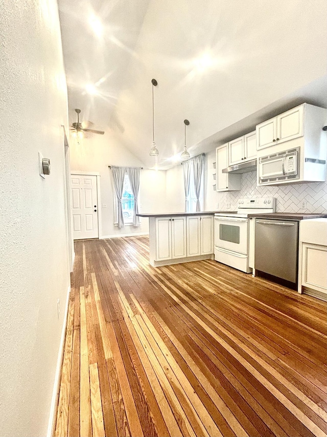 kitchen with hanging light fixtures, decorative backsplash, light wood-style floors, white cabinets, and white appliances