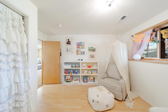 game room featuring visible vents, baseboards, and wood finished floors