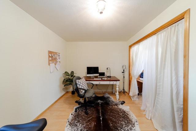 office featuring light wood-style flooring and baseboards