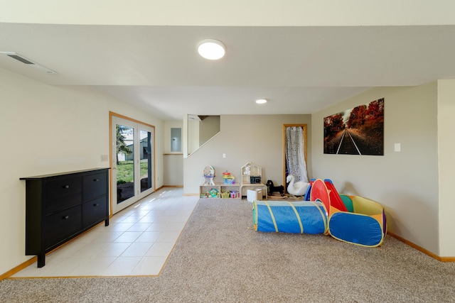 playroom featuring light tile patterned floors, visible vents, baseboards, and light colored carpet