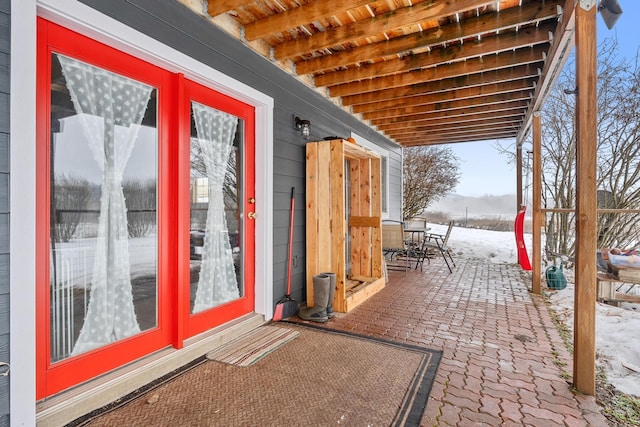 snow covered patio featuring outdoor dining area