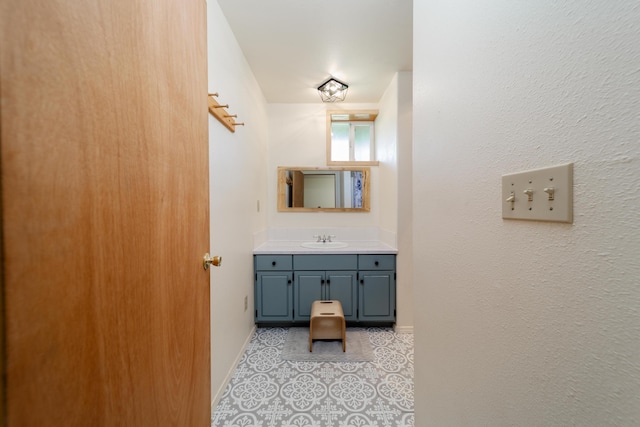 bathroom featuring tile patterned flooring, vanity, and baseboards