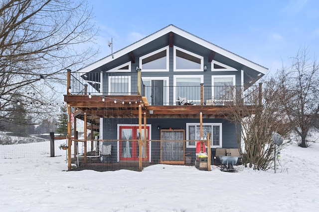 view of snow covered rear of property