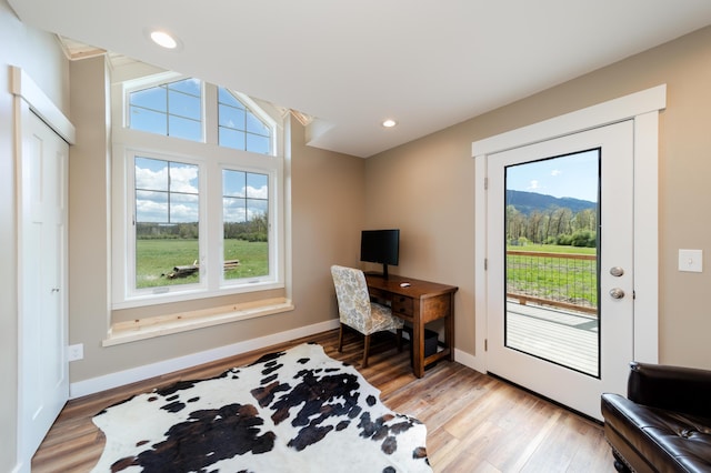 office area with light wood-style floors, recessed lighting, and baseboards