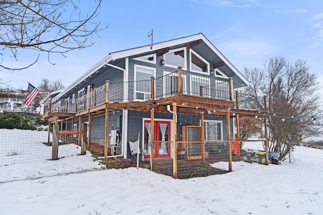 snow covered property with a garage