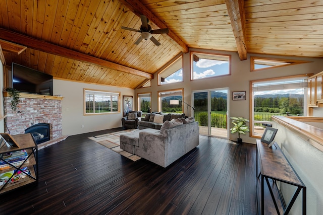 living area with dark wood-type flooring, wood ceiling, a fireplace, and beamed ceiling