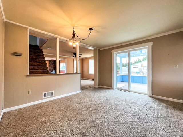 unfurnished room featuring ceiling fan, crown molding, and carpet flooring