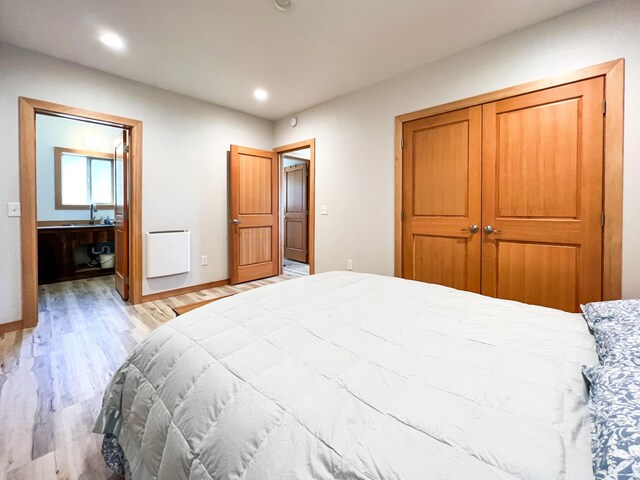 bedroom featuring light hardwood / wood-style flooring and a closet