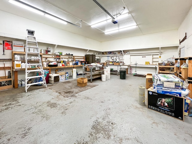 garage with a garage door opener and a workshop area