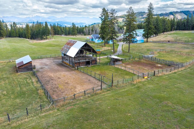 birds eye view of property featuring a mountain view and a rural view