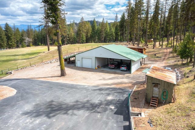 exterior space featuring a carport, a yard, and a garage