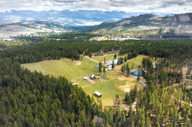 drone / aerial view featuring a water and mountain view