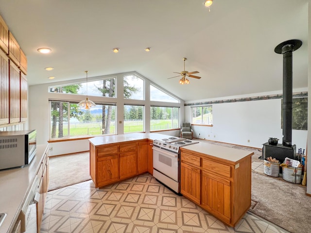 kitchen with kitchen peninsula, pendant lighting, a wood stove, lofted ceiling, and white electric range