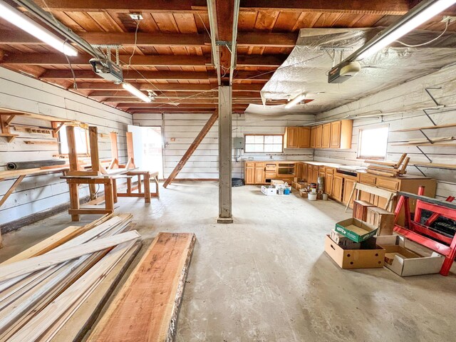 basement featuring wood ceiling and wooden walls