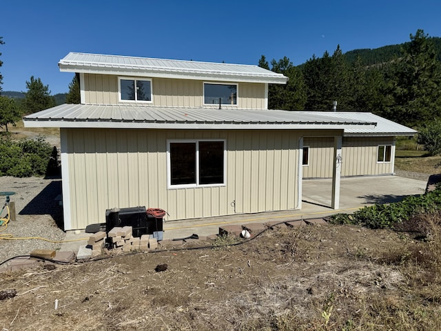 3305 Bradeen Rd, Rice, WA 99167 - back of property featuring a patio, a metal roof, and a view of trees