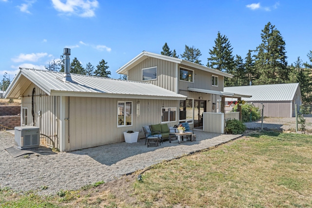 3305 Bradeen Rd, Rice, WA 99167 - back of house featuring a patio, a metal roof, a yard, an outdoor hangout area, and board and batten siding