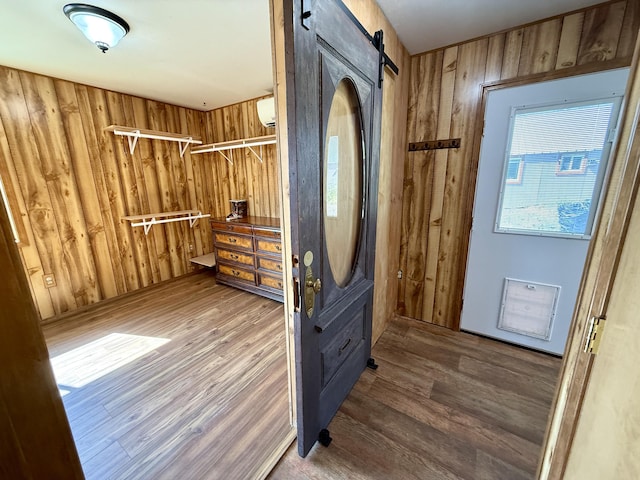 3305 Bradeen Rd, Rice, WA 99167 - foyer entrance with wood finished floors, wood walls, a wall mounted AC, and a barn door