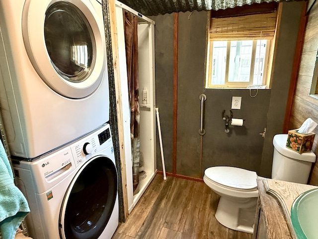 3305 Bradeen Rd, Rice, WA 99167 - full bathroom featuring stacked washer / dryer, wood finished floors, a shower, and vanity