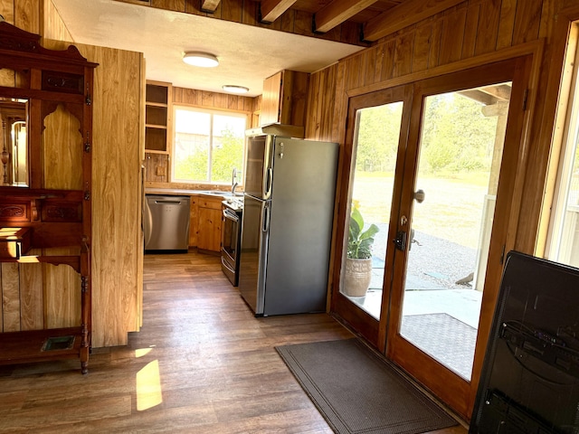 3305 Bradeen Rd, Rice, WA 99167 - kitchen with appliances with stainless steel finishes, wood finished floors, french doors, brown cabinetry, and wood walls