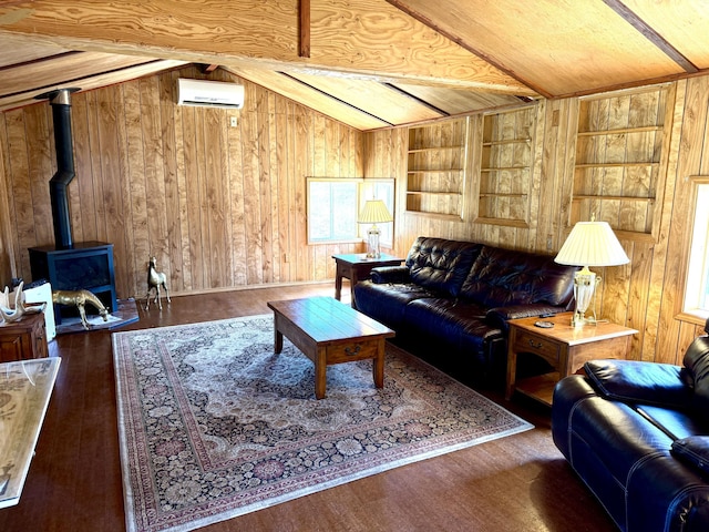 3305 Bradeen Rd, Rice, WA 99167 - living area with a wall mounted air conditioner, wood walls, wood finished floors, built in shelves, and a wood stove