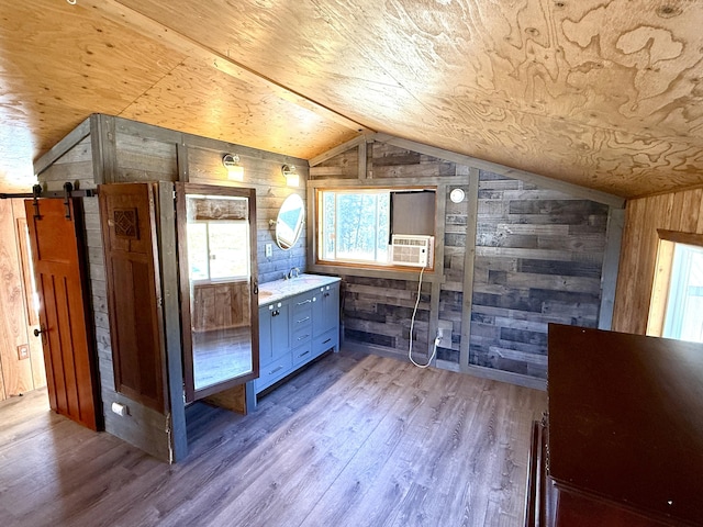 3305 Bradeen Rd, Rice, WA 99167 - bathroom featuring wooden walls, lofted ceiling, healthy amount of natural light, wood finished floors, and vanity