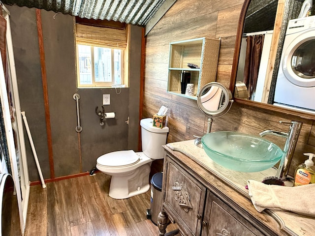 3305 Bradeen Rd, Rice, WA 99167 - bathroom featuring washer / dryer, wood finished floors, vanity, and wood walls