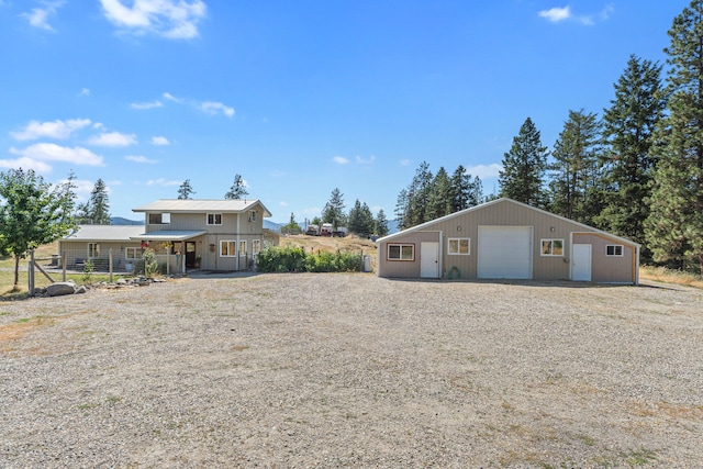 3305 Bradeen Rd, Rice, WA 99167 - back of property featuring a detached garage, an outbuilding, and gravel driveway