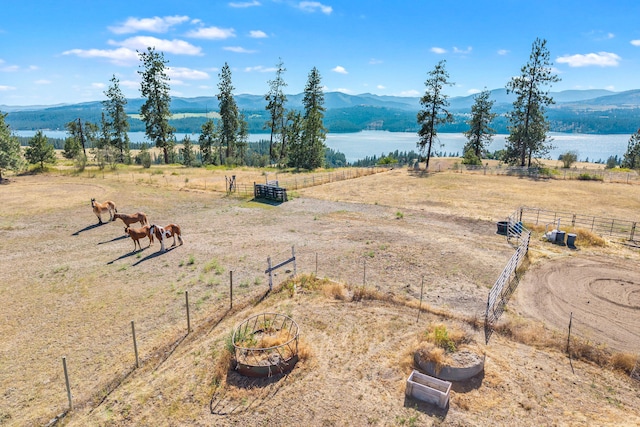 3305 Bradeen Rd, Rice, WA 99167 - water view featuring rural landscape, an enclosed horse arena, and a mountainous background