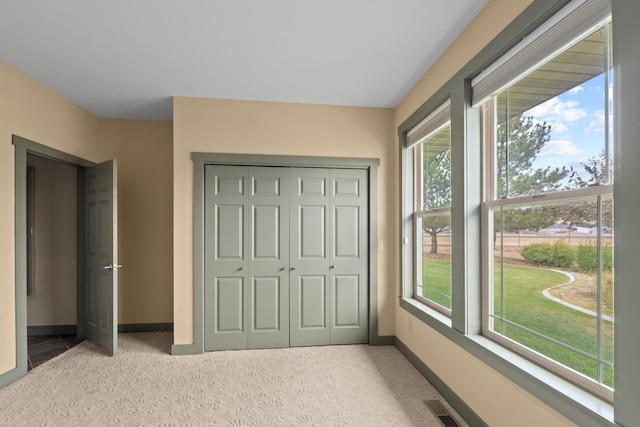 carpeted bedroom with a closet