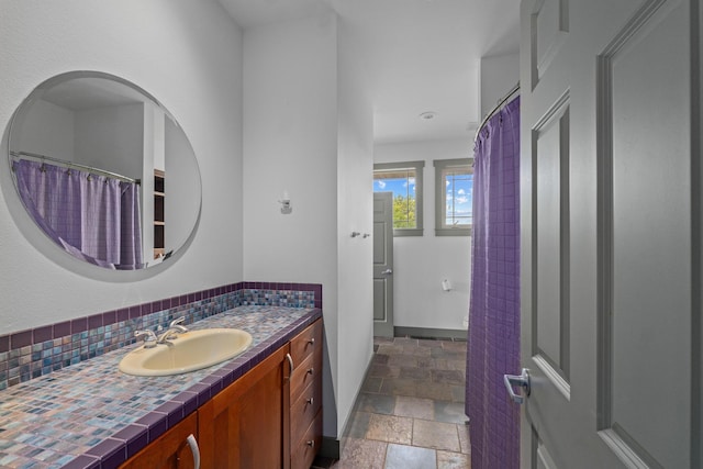 bathroom with vanity and tasteful backsplash