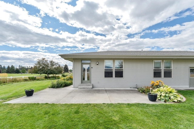 back of house featuring a yard and a patio area