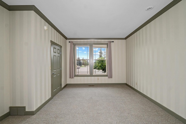 carpeted spare room featuring crown molding