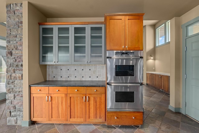 kitchen featuring double oven and decorative backsplash